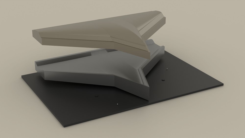 The machined pair the bed stands in for: male mandrel lifted clear of the female cavity on its baseplate